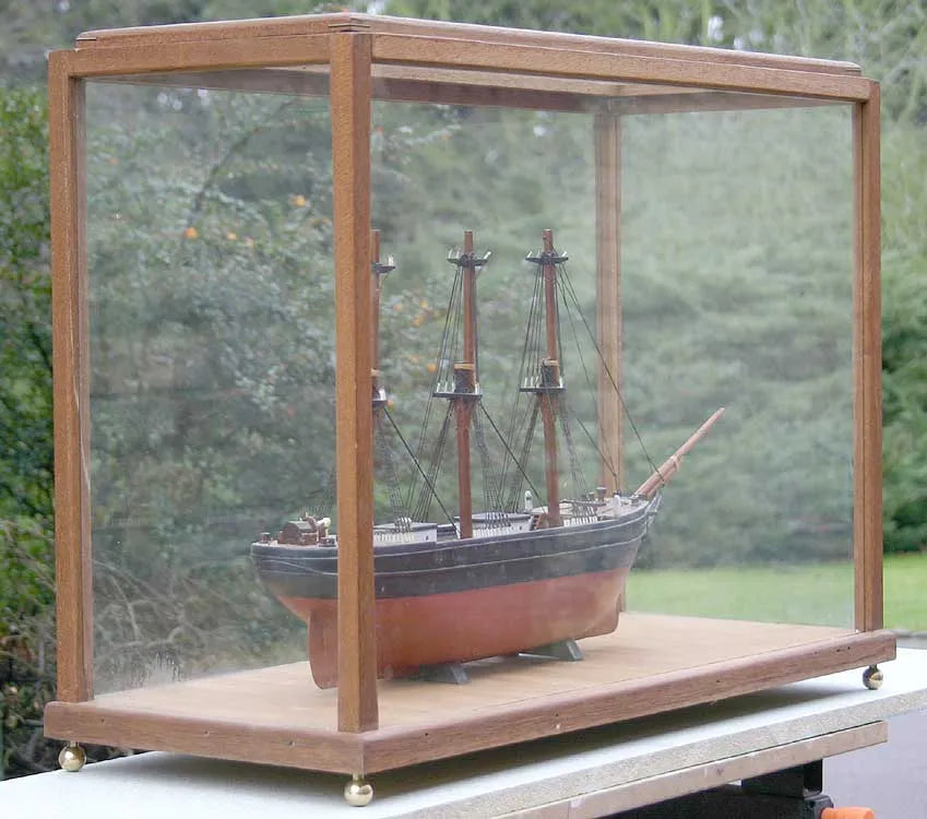 Wooden sailing ship in glass case