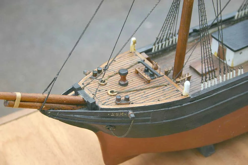 Wooden sailing ship in glass case