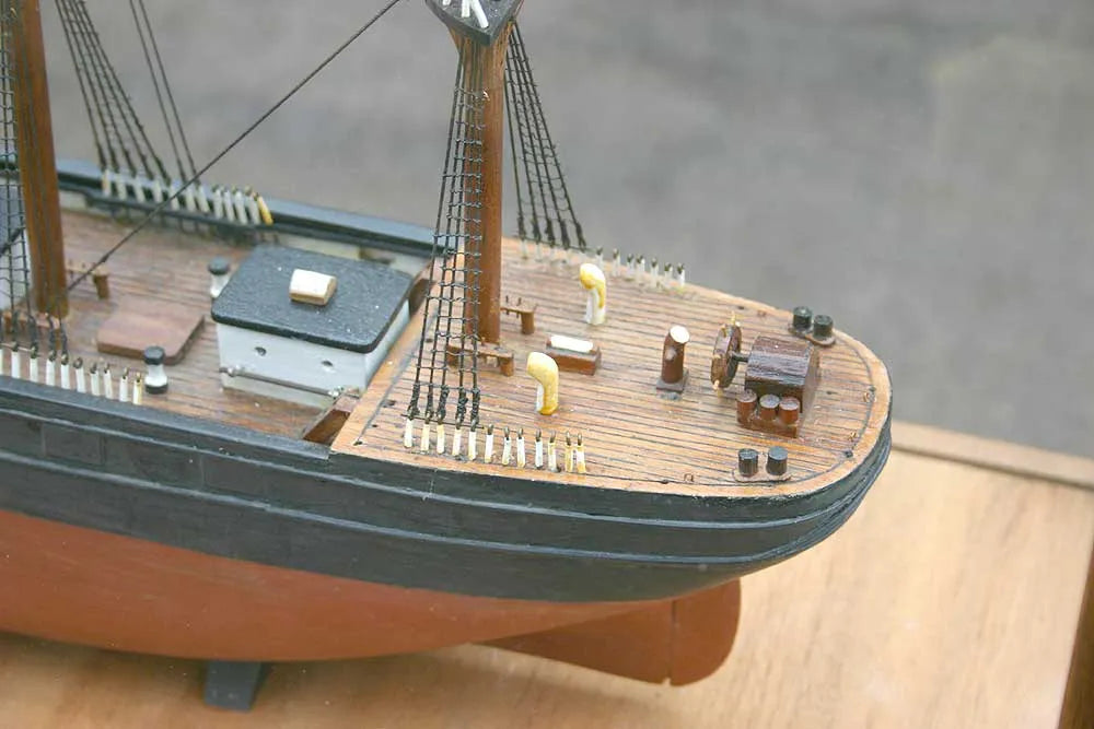 Wooden sailing ship in glass case