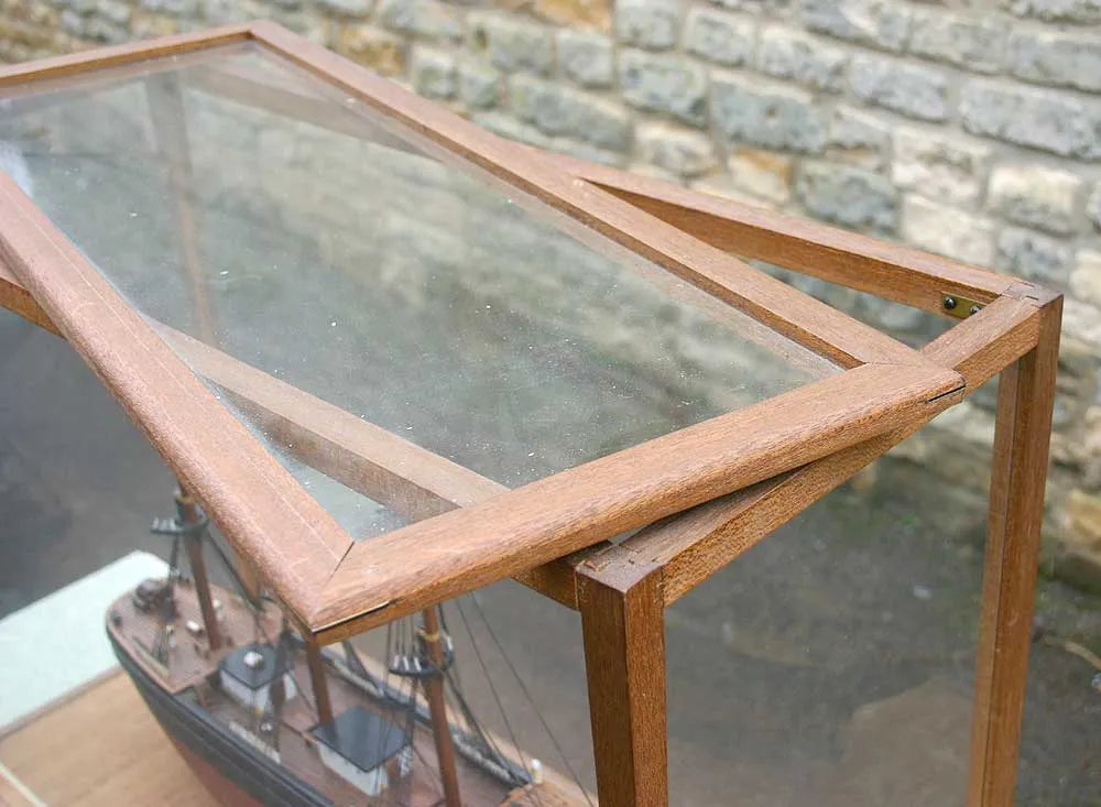 Wooden sailing ship in glass case