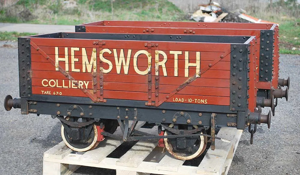 Five 10 1/4 inch gauge wagons and brake van
