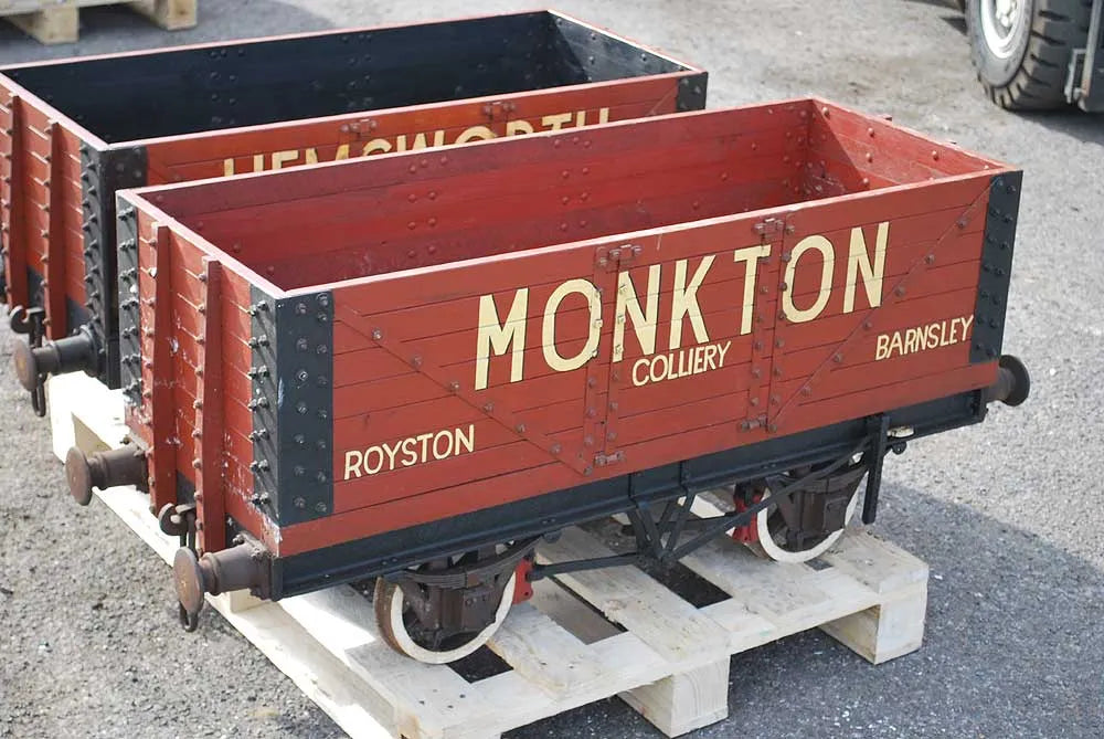 Five 10 1/4 inch gauge wagons and brake van