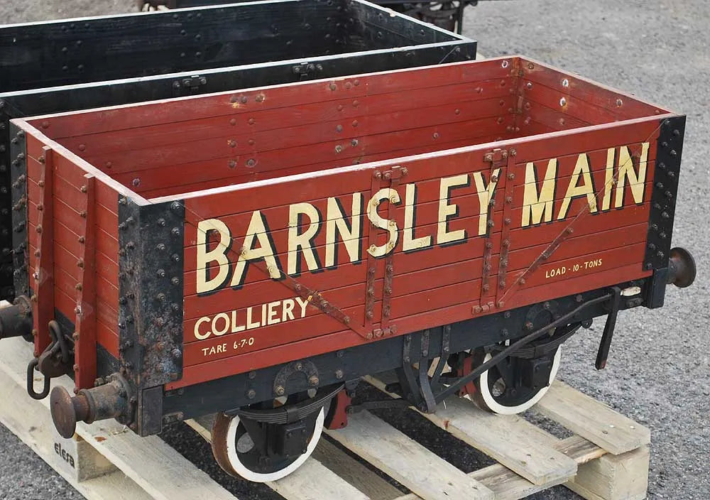 Five 10 1/4 inch gauge wagons and brake van