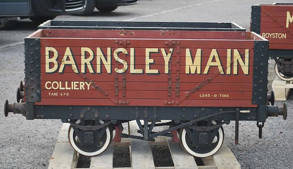 Five 10 1/4 inch gauge wagons and brake van