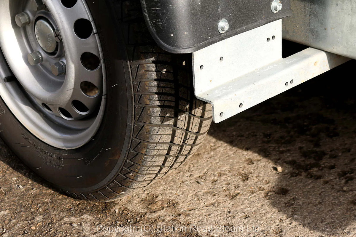 Two wheel tilt bed trailer
