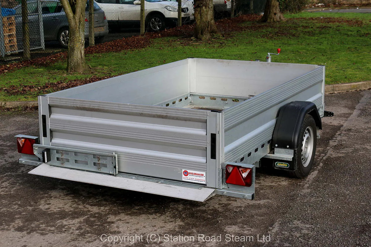 Two wheel tilt bed trailer