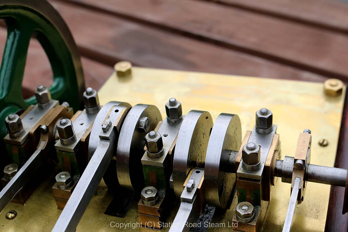 Horizontal twin mill engine on brass supports with hardwood base