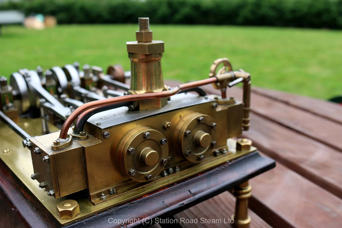 Horizontal twin mill engine on brass supports with hardwood base